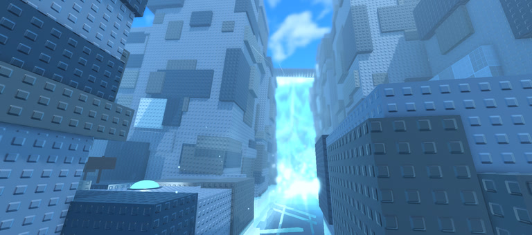 Looking up between tall blue-grey towers at a bright waterfall.